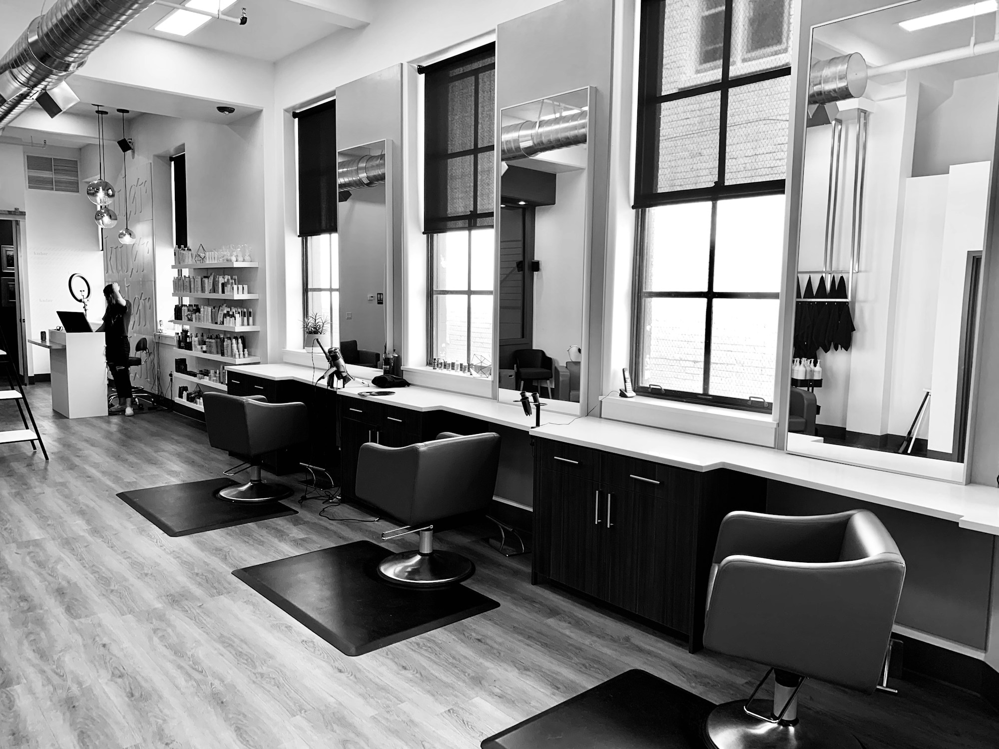 A light-filled salon with mirrors and comfortable styling chairs