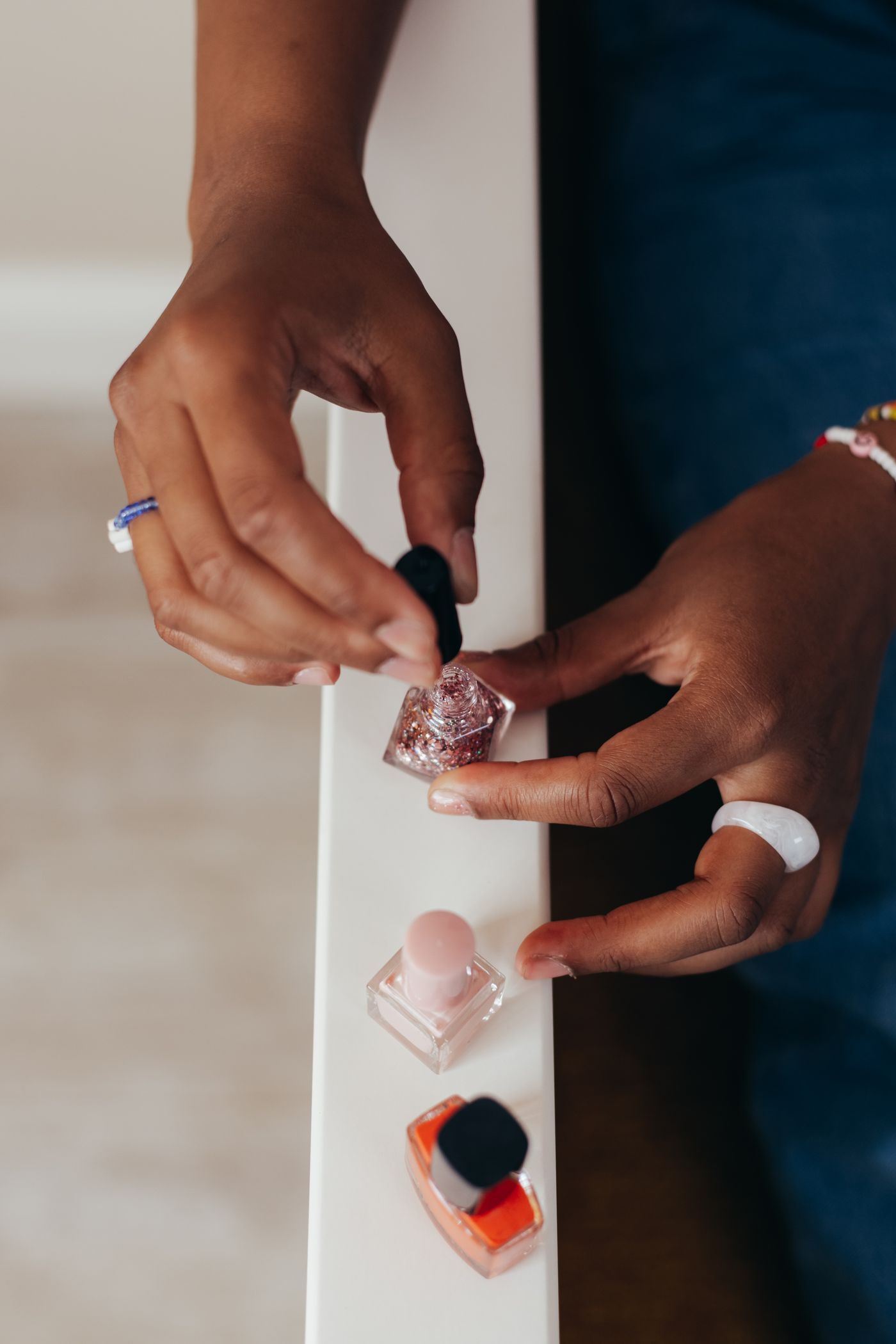 Hands holding a glitter polish bottle