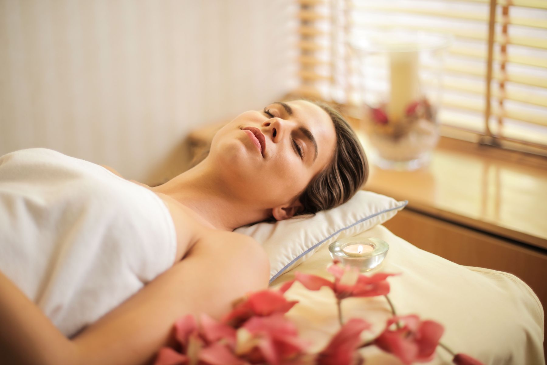 Warm light and soft linens during a peaceful body ritual